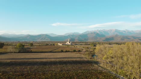 -Alaverdi-Church-And-The-Surrounding-Farmland-With-Mountain-Range-In-Kakheti,-Georgia