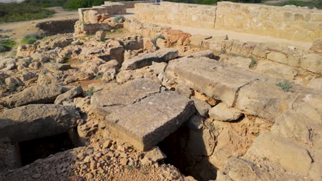 An-archaeological-site-featuring-partially-excavated-stone-structures-and-ruins-at-the-Tombs-of-the-Kings-in-Pafos