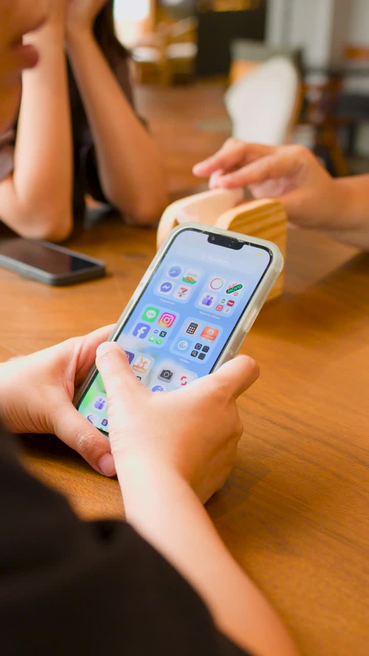 A person uses their thumb to scroll through mobile applications on a smartphone screen