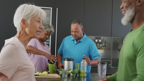 Happy-senior-diverse-people-cooking-in-kitchen-at-retirement-home