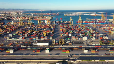 left to right aerial traveling over port of valencia trucks, containers spain