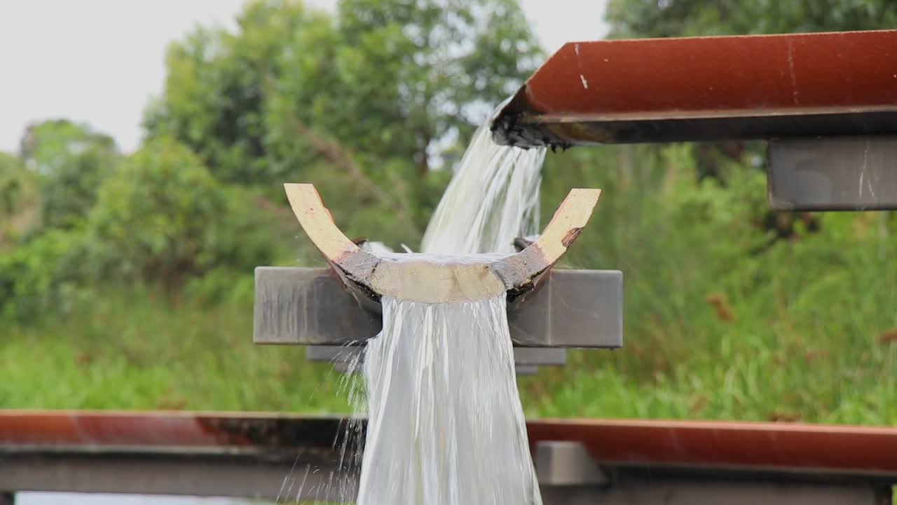 A raised multiple drainage system filling a wetlands lake with fast flowing water.