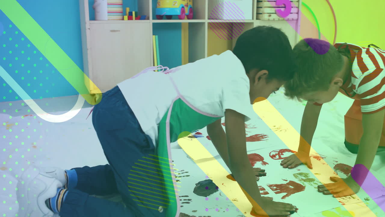 Child painting on floor with colorful shapes animation over classroom background