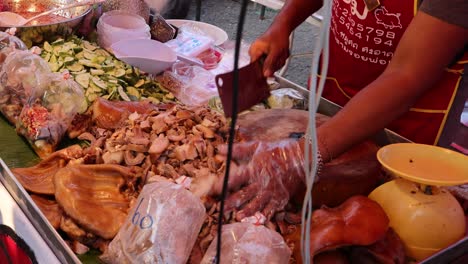 person chopping and packaging cooked meat