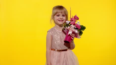 Little-child-girl-with-fashion-makeup-standing-with-bouquet-of-flowers-isolated-on-yellow-background