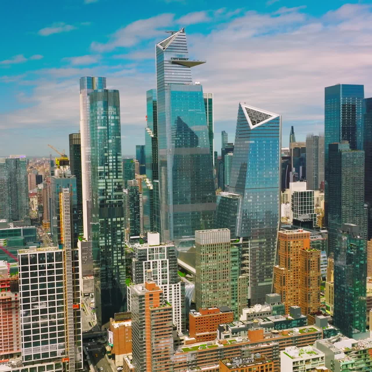 Azure sky reflecting in the mirror windows of skyscrapers. New York city diverse architecture on beautiful sunny day