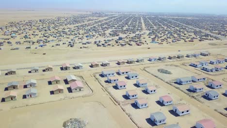 aerial over a strange abandoned town of empty lonely suburban tract houses in the desert of namibia africa 1