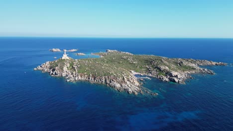 Lighthouse-on-small-rocky-island-in-Sardinia,-Italy---Aerial-4k