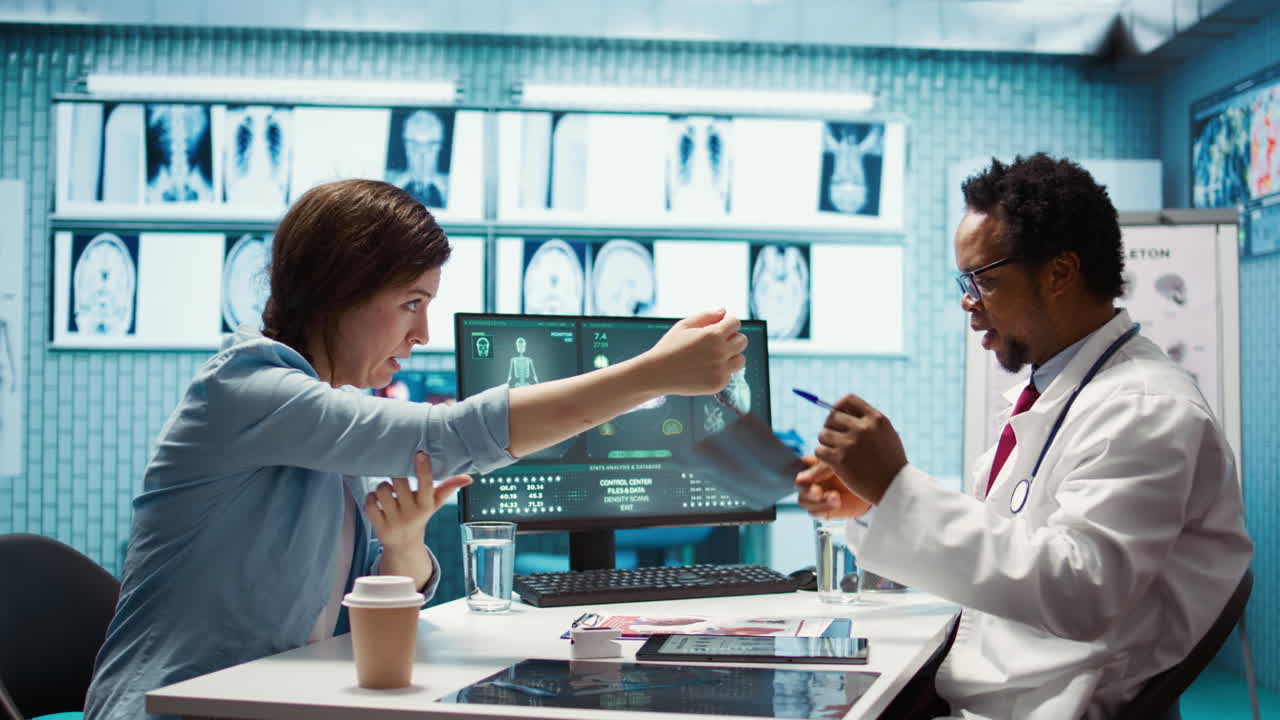 General practitioner examining x ray scan test results with patient