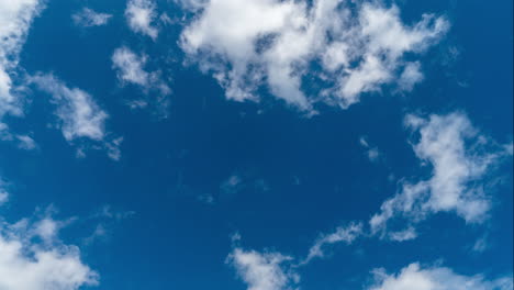 white fluffy clouds time lapse with blue sky background