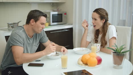 happy couple having breakfast together at home.