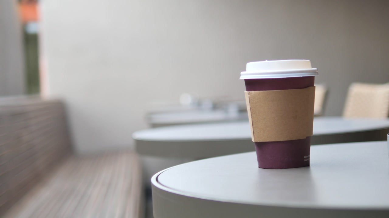 Disposable Coffee Cup on an Empty Outdoor Cafe Table