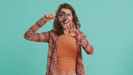 investigator researcher woman with magnifying glass near face looking into camera with big zoom eye