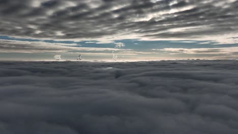 abstract aerial view between dark gray layers of clouds with blue sky between for a very moody look