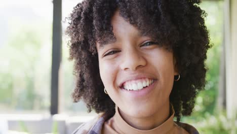 portrait of happy african american teenage girl, smiling and laughing, slow motion
