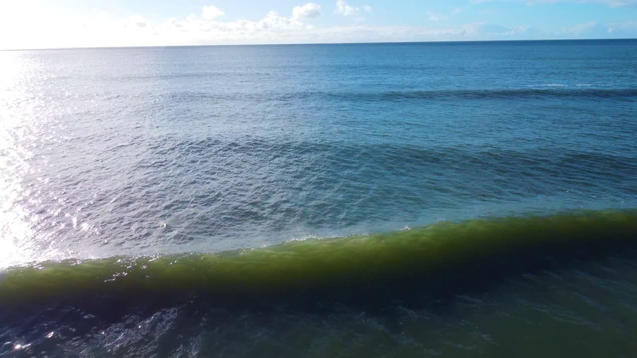 Flying Low Over Small Beach with Bright Sun Flare Over Calm Ocean. Travel Nature Drone Clip. Beautiful Welsh Gower Peninsula Coast