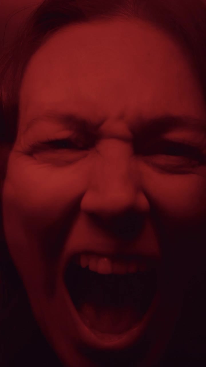 Surreal Kaleidoscopic Portrait of Terrified Woman Screaming in Red Light