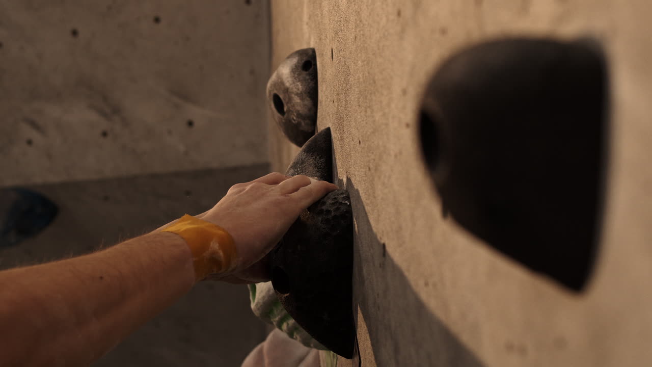 Person Climbing on a Climbing Wall