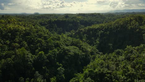 Aerial-Panoramic-Sunrise-Landscape-above-Green-Tropical-Jungle-and-Hills-Background