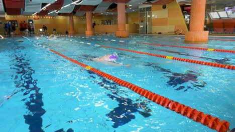 people swimming in an indoor pool