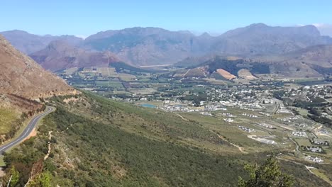 a slow pan across franschhoek mountain pass with the franschhoek town visible below