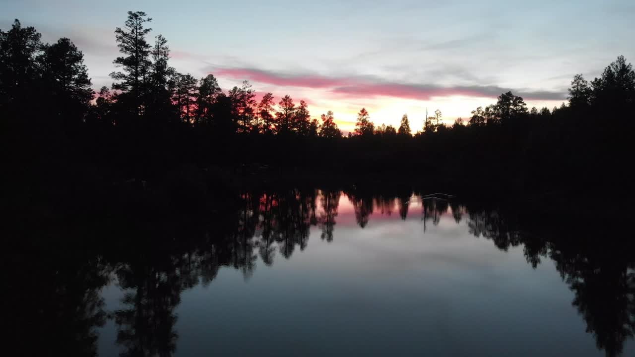 Flying over a mirror like lake in northern Arizona at white horse lake