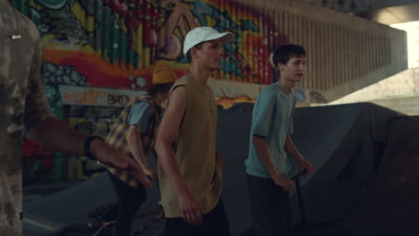 casual boys relaxing skatepark together. active male teenagers communicating.