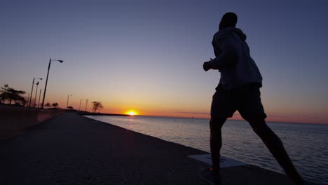 silhouette of african american male running at sunset