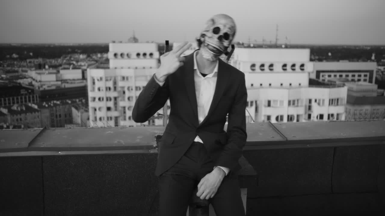 Man in Skull Mask on Rooftop Overlooking City