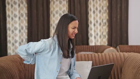 Indian-woman-having-back-pain-after-working-on-laptop