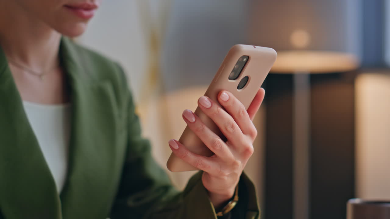 Office manager swipe screen at work closeup. Woman hands scrolling mobile phone