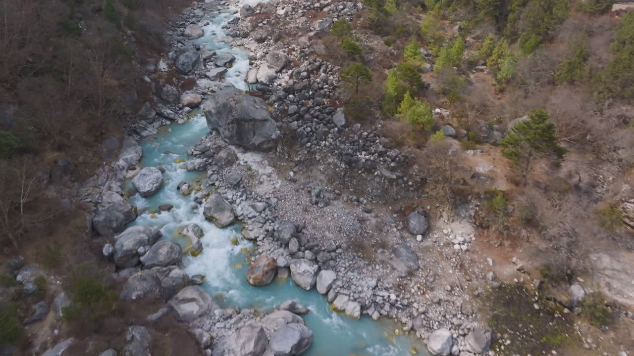 Dudh Koshi river flows gently through Himalayan hills enroute to Everest Base Camp, surrounded by scenic terrain ideal for trekking tourists in Nepal