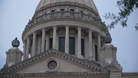 rack focus in, close up columns: stormy skies over the mississippi state capitol building. jackson, ms.
