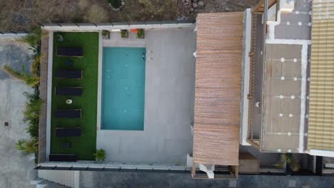 aerial view of a luxury villa with private pool and sunbeds