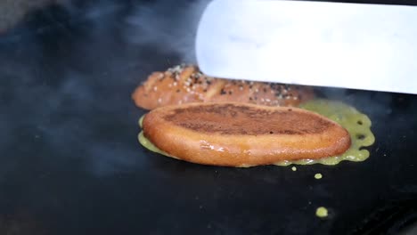 closeup: preparation of healthy vegan burger with vegan sauce