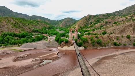 Breathtaking-drone-footage-of-Sucre-Bridge-soaring-over-the-Pilcomayo-River,-connecting-Yotala-and-Betanzos-villages-in-Bolivia