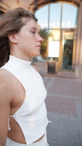 young woman walking in city street