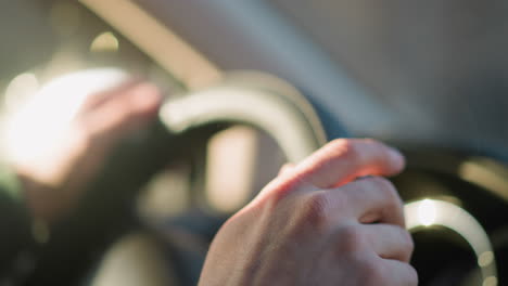 close-up view of a man's hands gripping a car steering wheel, highlighting the texture and details of the hands and the wheel