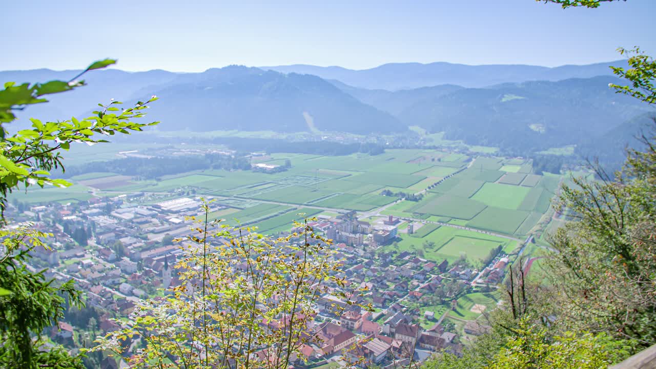 Right to left pan shot of a beautiful landscape with mountains in the background. Green window, Slovenia