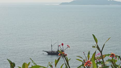 luxury sailing yacht moored in the waters of a tropical island