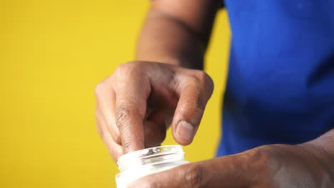 man applying cream to his skin