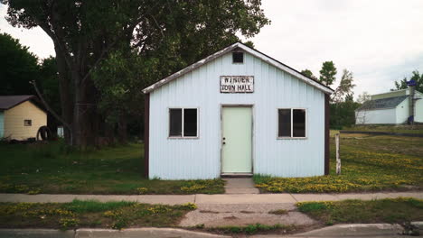 Pan-in-Shot-of-Abandoned-Small-Town-Hall-in-Rural-Suburb