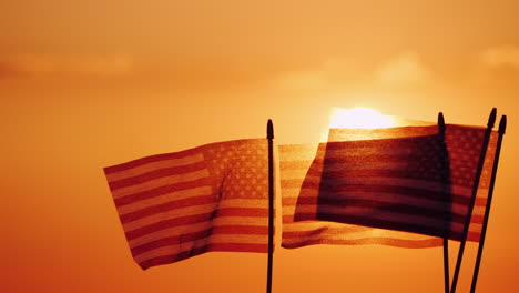 Several-American-Flags-Against-The-Setting-Sun-And-Orange-Sky