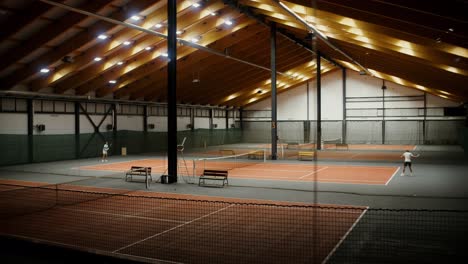 indoor tennis court with players