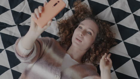 woman taking a selfie in bed