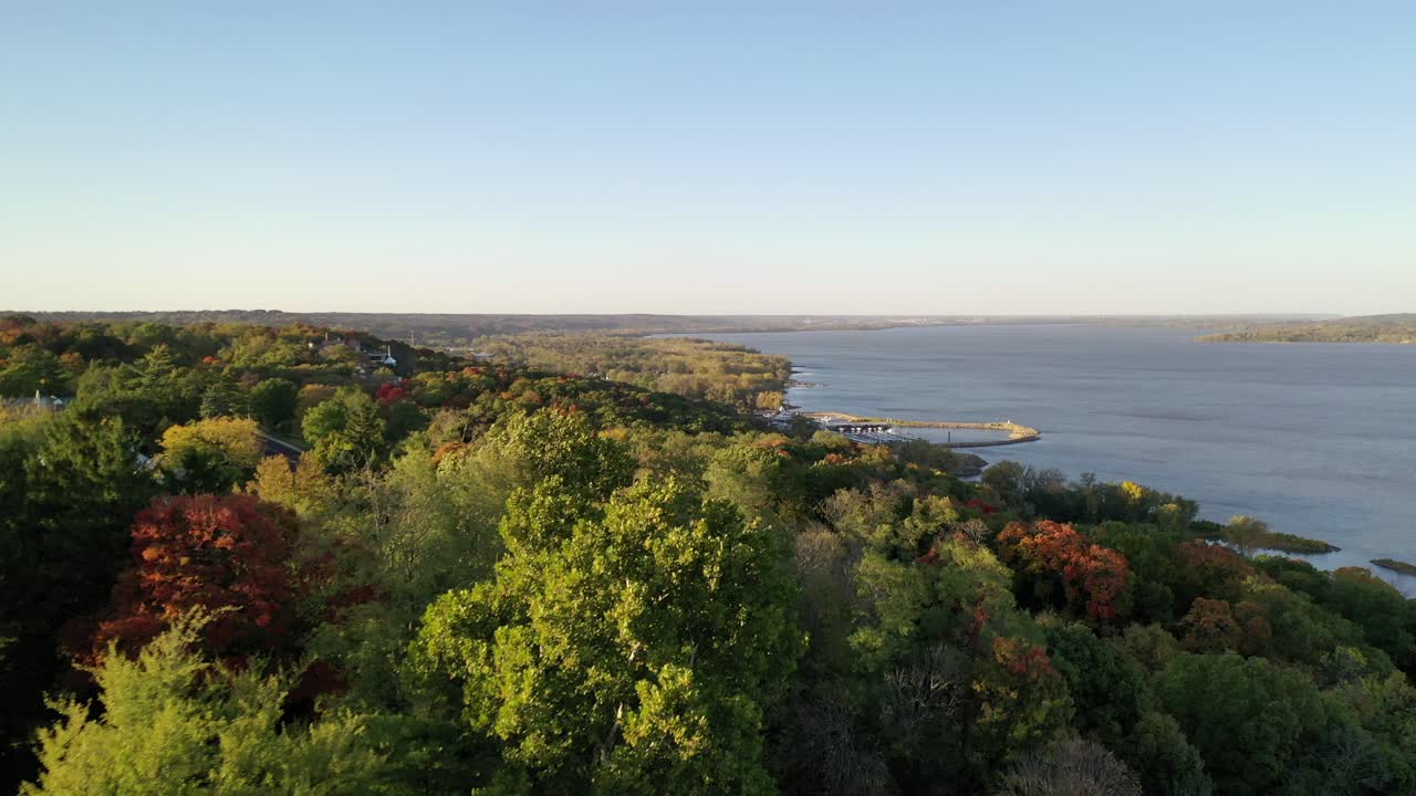 Gorgeous reveal from behind the colorful autumn trees of the Illinois river at Grandview Drive in Peoria