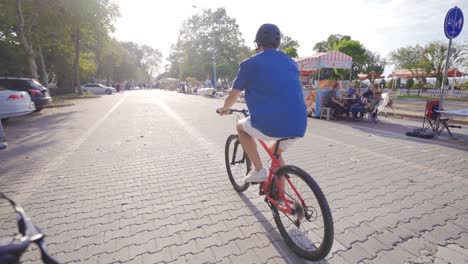 young man riding a bicycle on a city street.