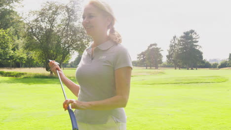 mature couple playing round on golf together sitting in buggy with score card
