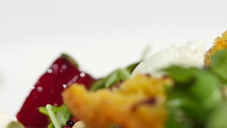 close-up of a gourmet salad with croutons, beets, and cheese