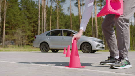 man placing traffic cones